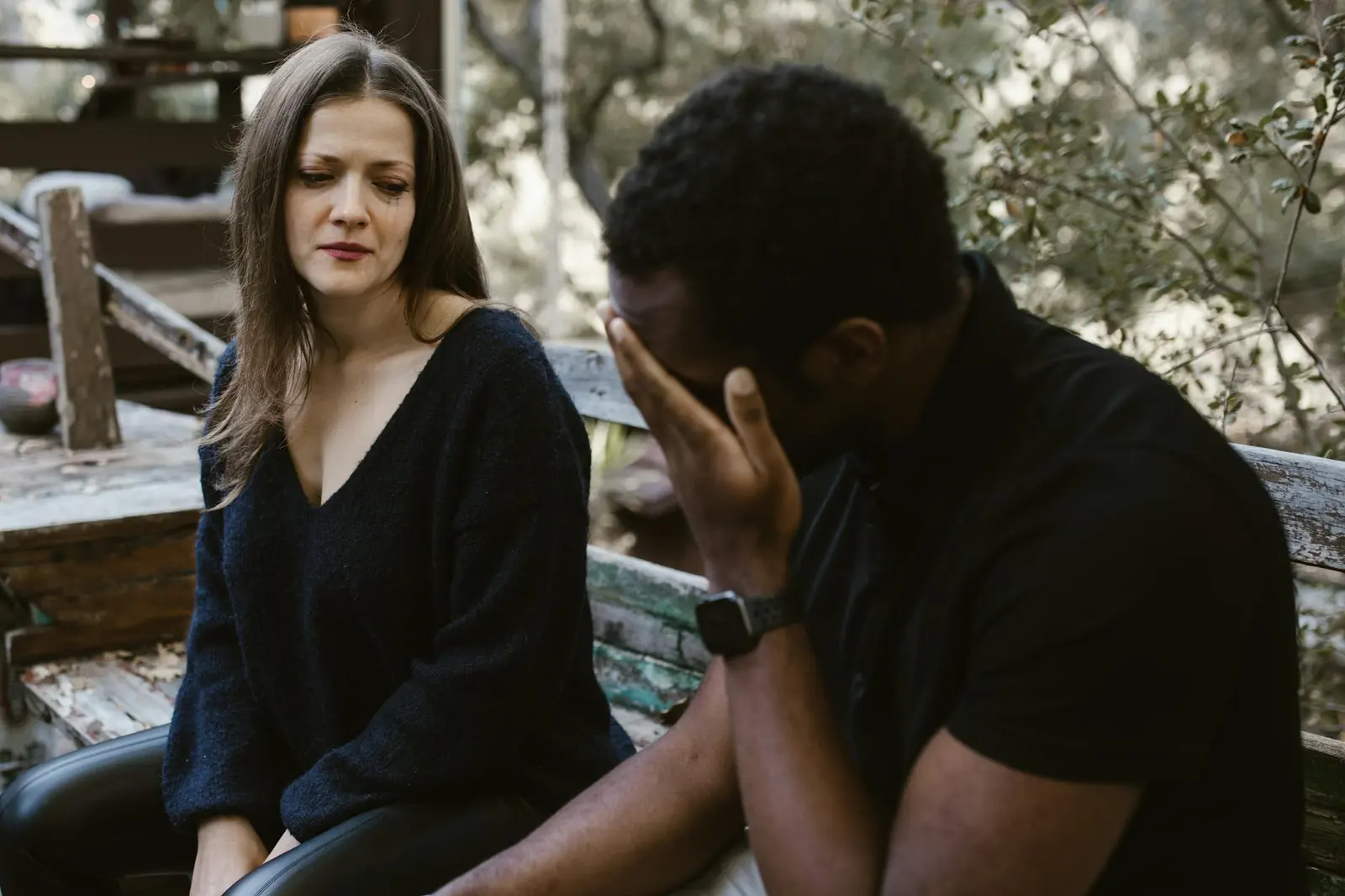 A couple sitting outside during a difficult breakup conversation