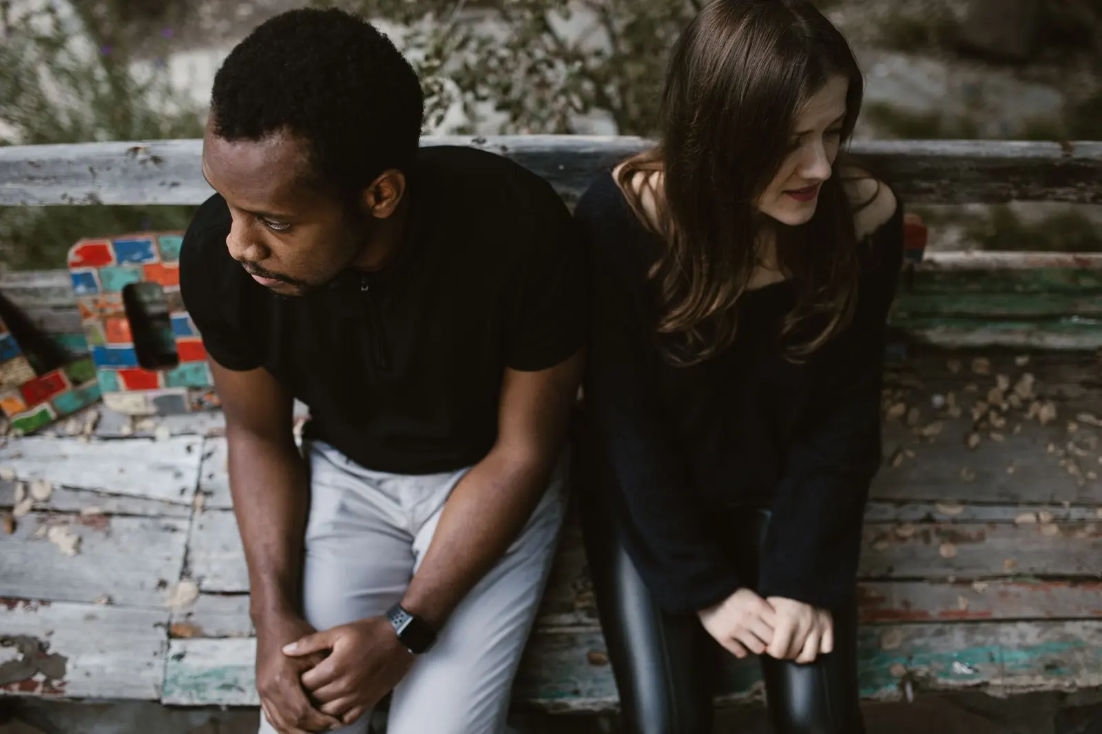 Clingy Girlfriend: Signs, Meaning, and What to Do: a couple sitting apart while processing relationship space
