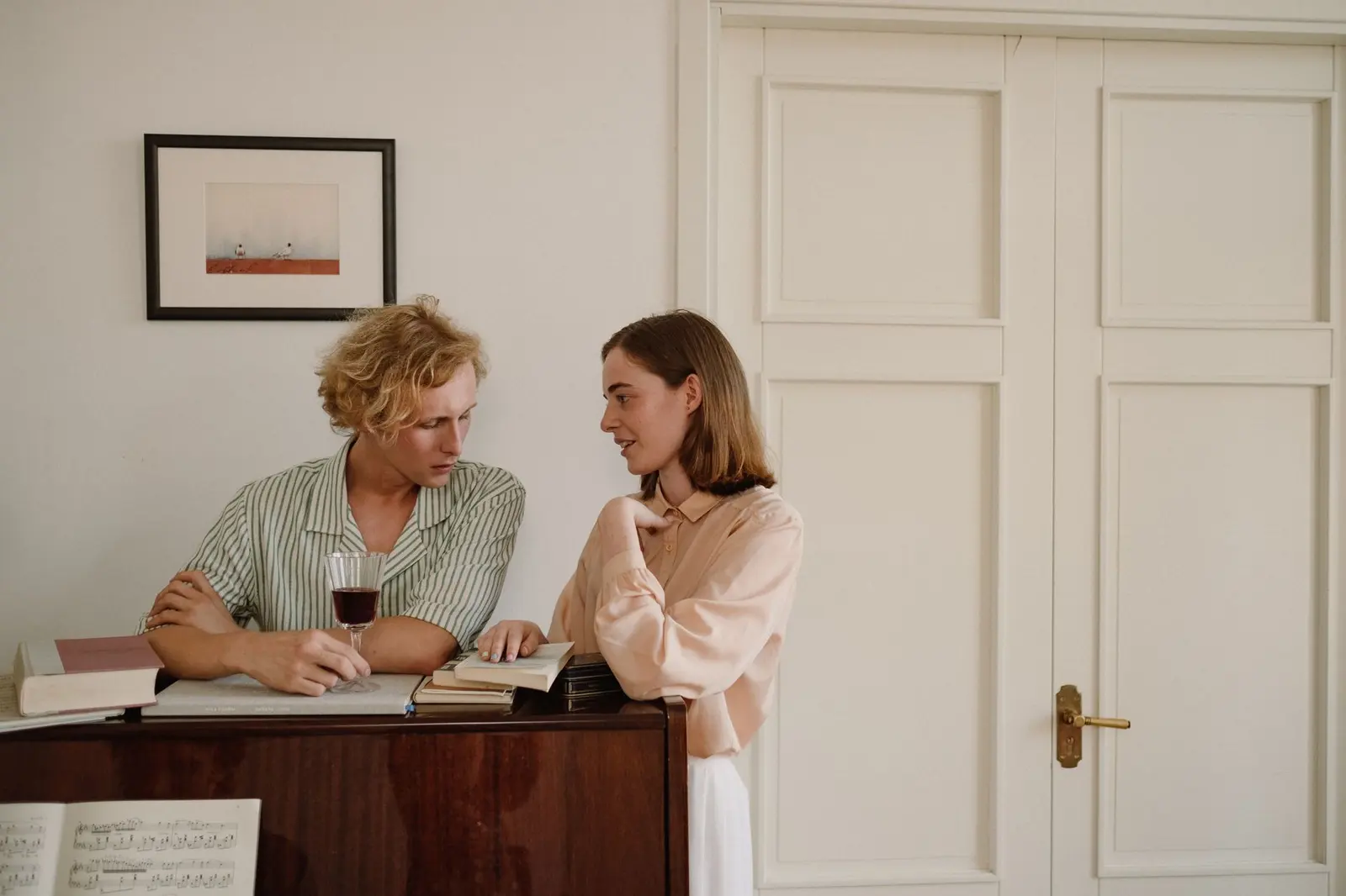 Two people talking beside books and notes, like a thoughtful relationship pace agreement