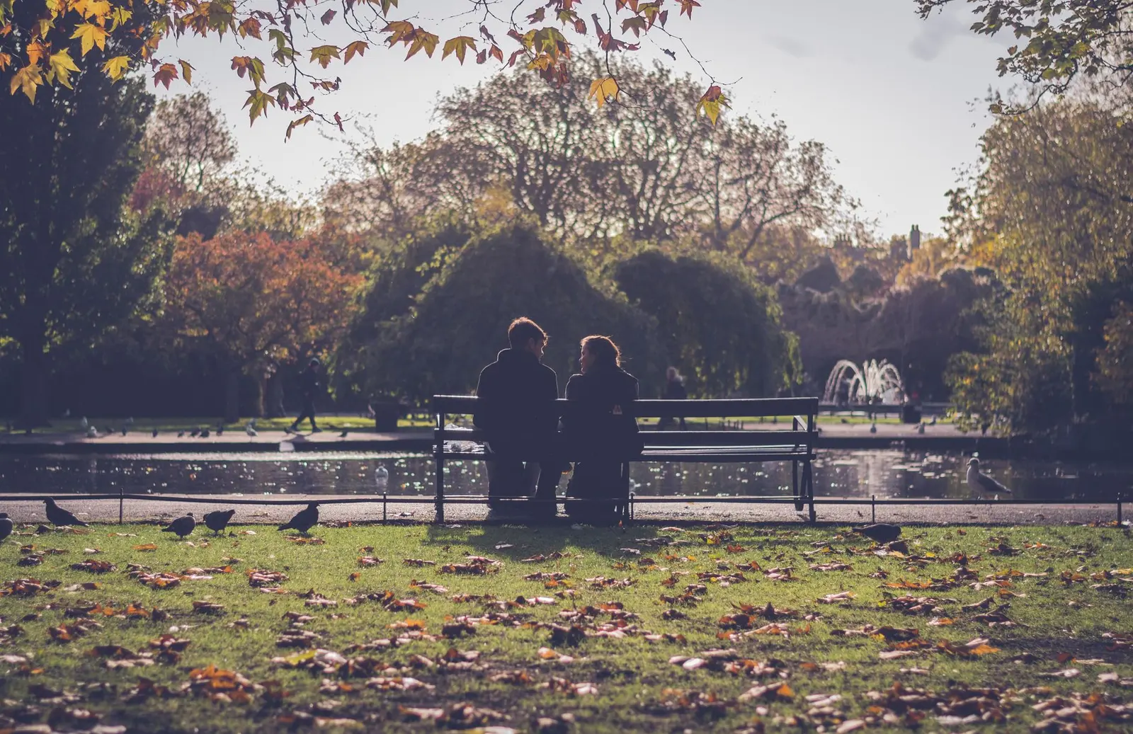 Two people sitting on a park bench during a quiet relationship check-in