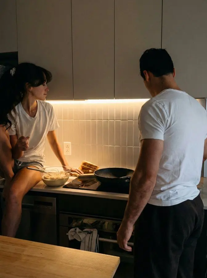 May-December relationship: two partners talking while cooking together at home
