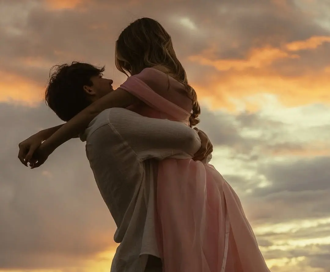 May-December relationship: a couple holding each other outdoors at sunset