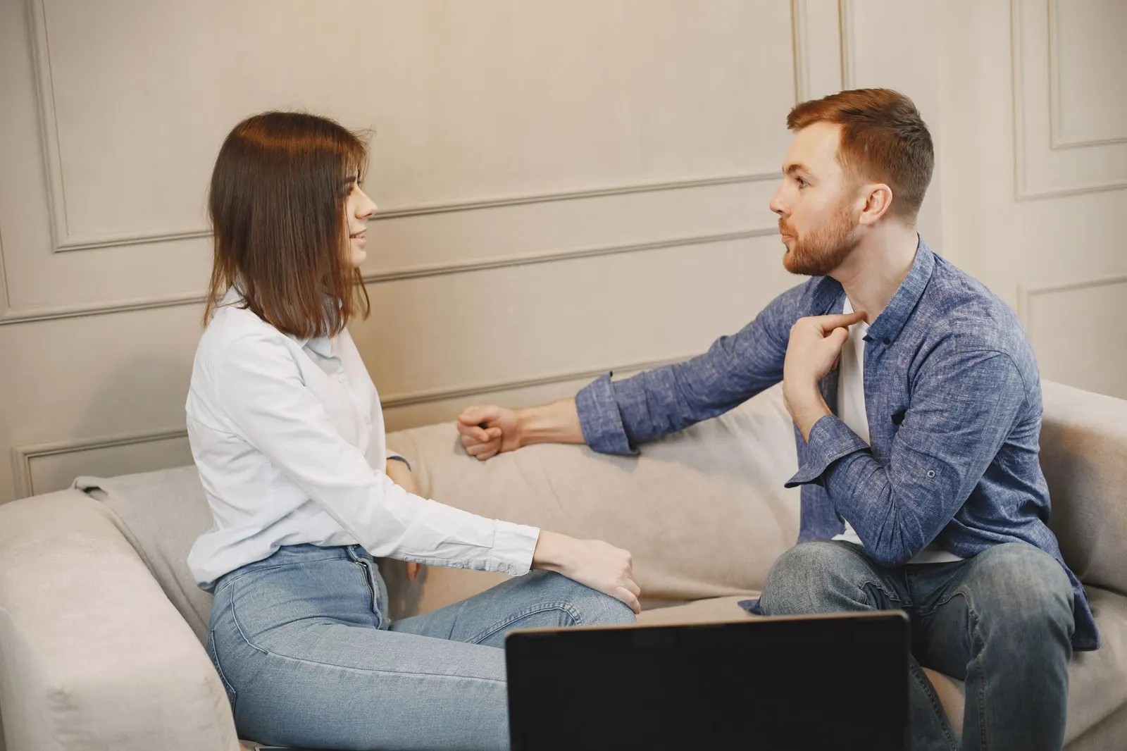 Two people sitting on a sofa during an honest relationship conversation about boundaries