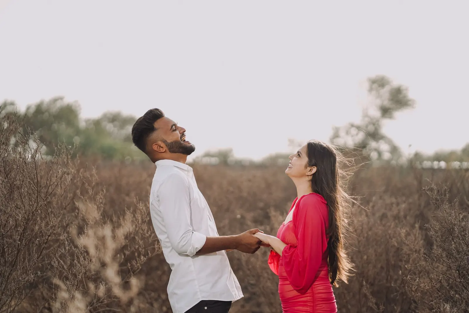 What to look for in a guy: a relaxed couple laughing together outdoors