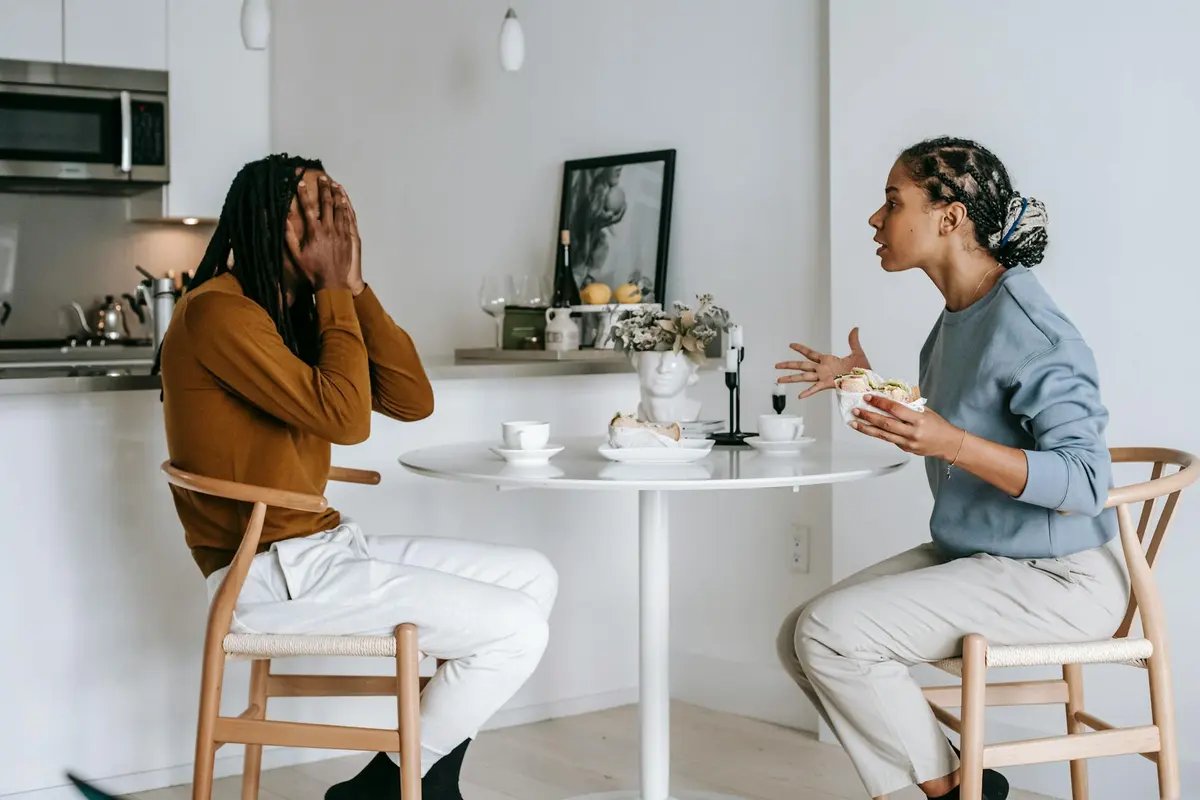A couple talking in a kitchen before turning the evening into a calmer check-in